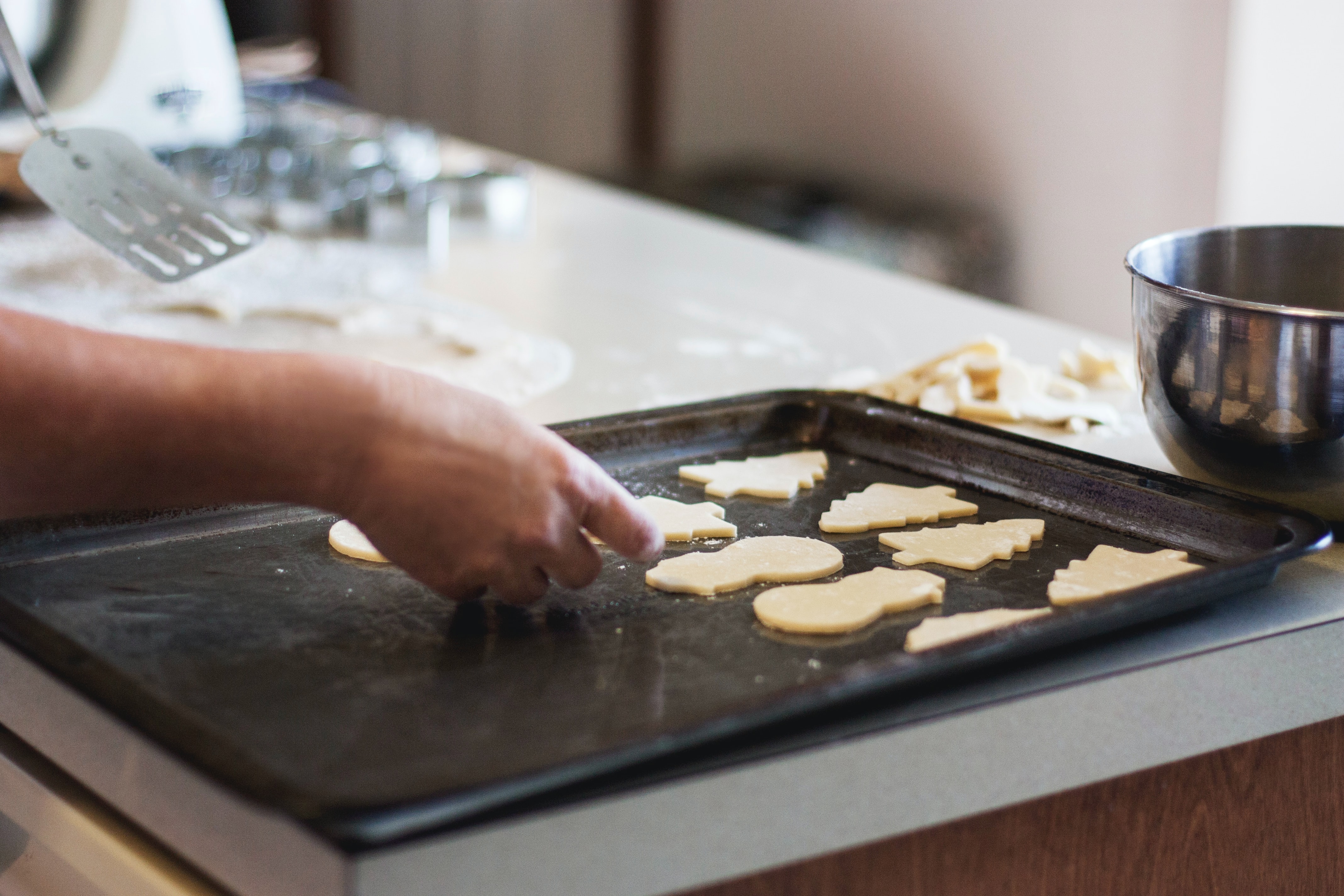 tray of unbaked different shaped sugar cookies